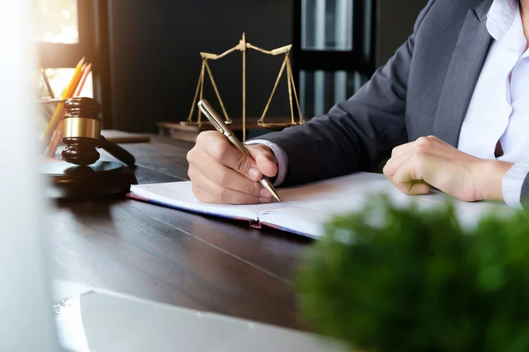 Woman holding a pen in a lawyers office