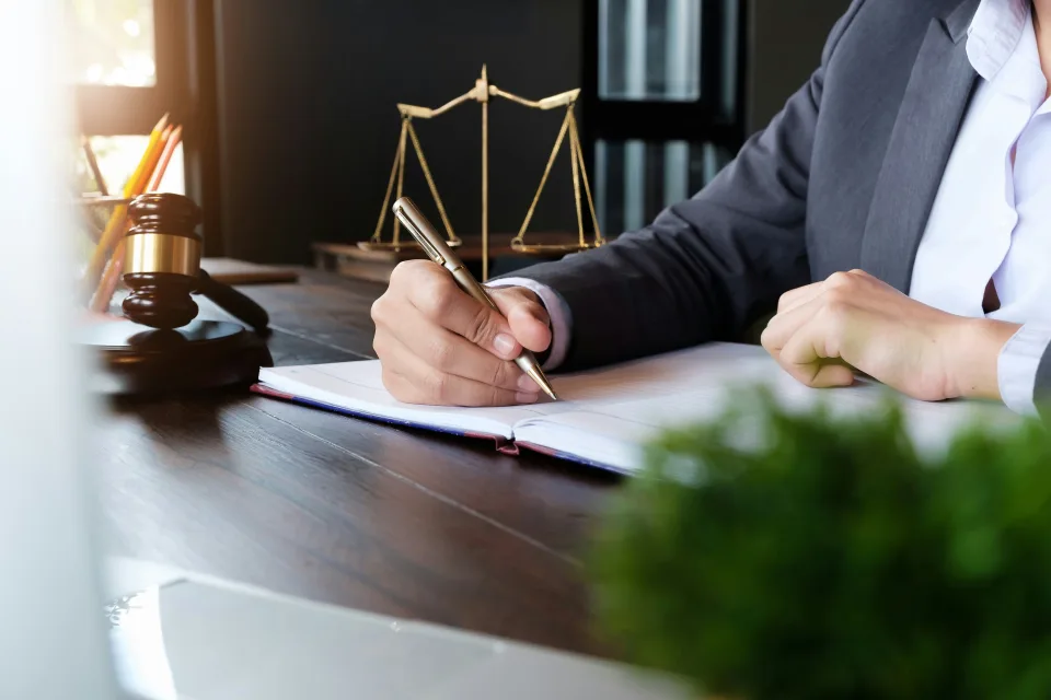 Woman holding a pen in a lawyers office